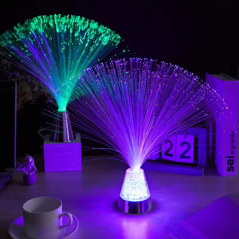 Fiber optic light emitting green and purple colors on a table with a cup and saucer.