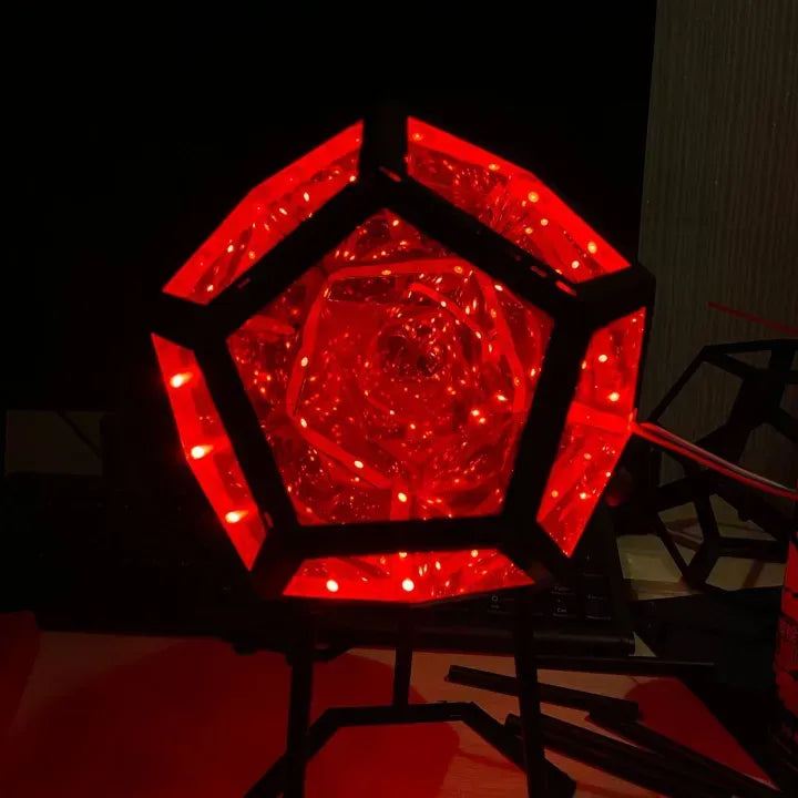 Red crystal-like geometric lamp on a dark background