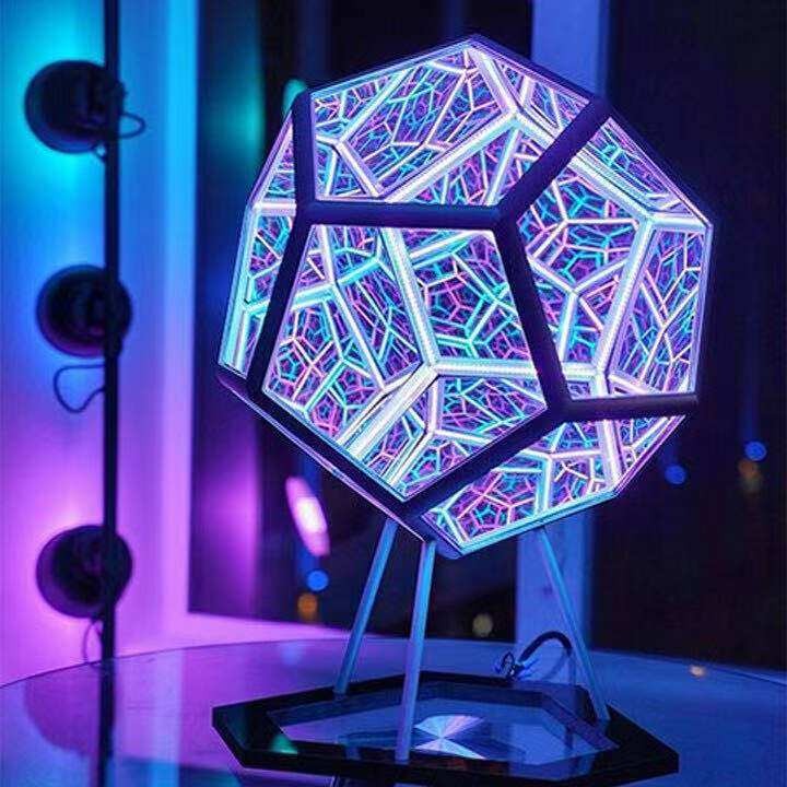 Geometric lamp with colorful, stained-glass-like design on a stand.