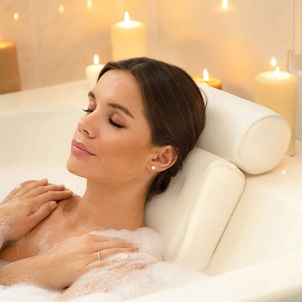 Woman relaxing in a bubble bath with candles in the background
