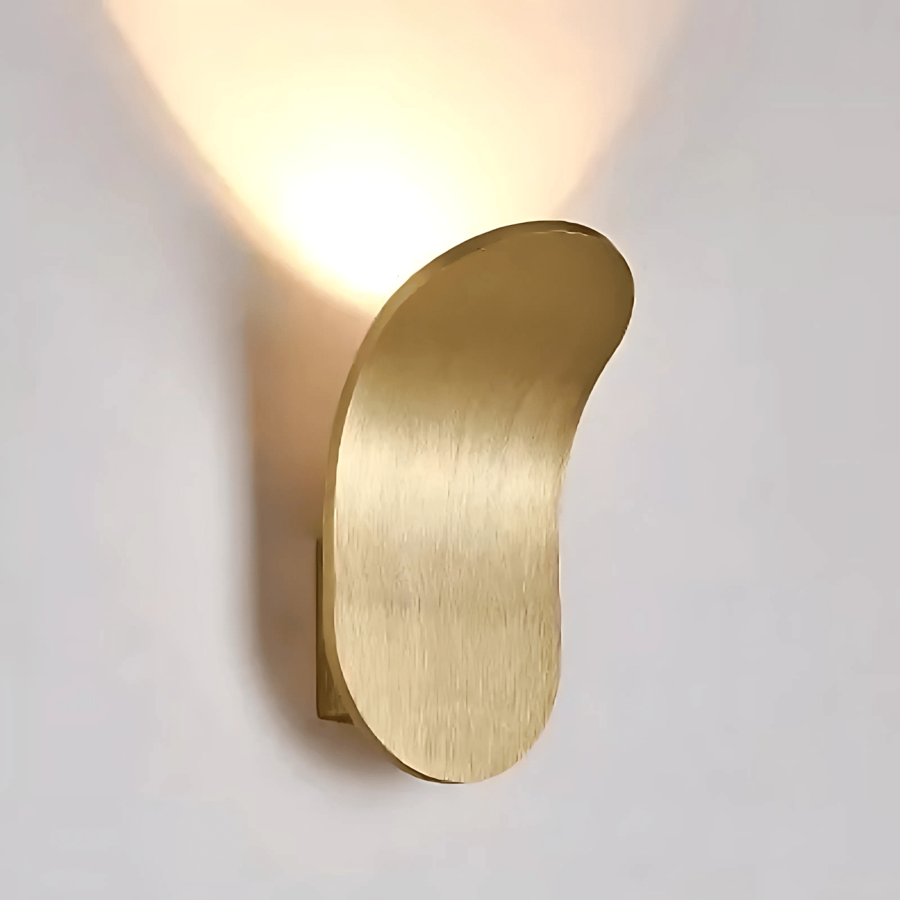 Gold wall sconce on a light gray background