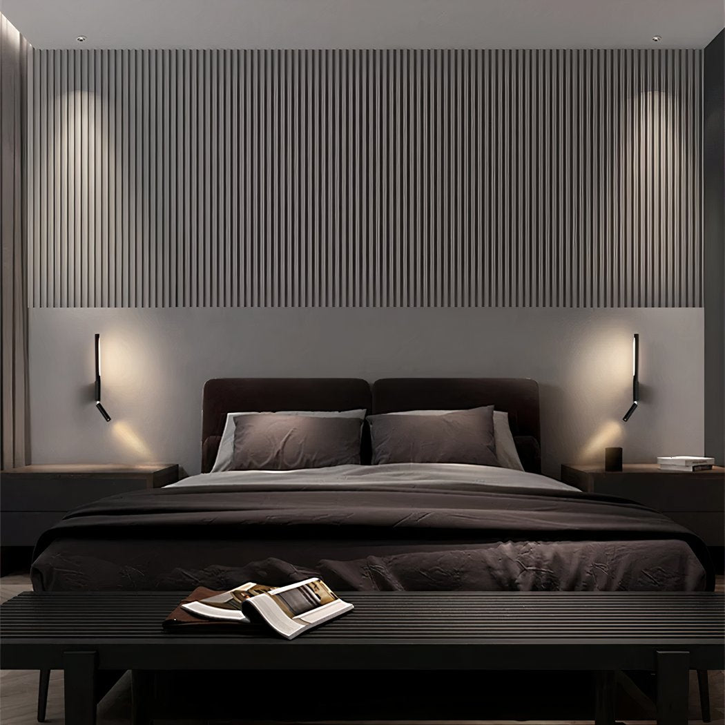 Modern bedroom with dark bedding and wall lights