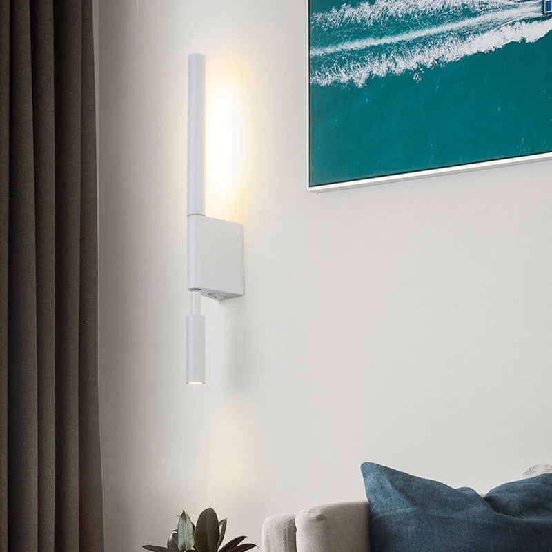Modern wall sconce on a wall with a painting of an ocean scene in a room.