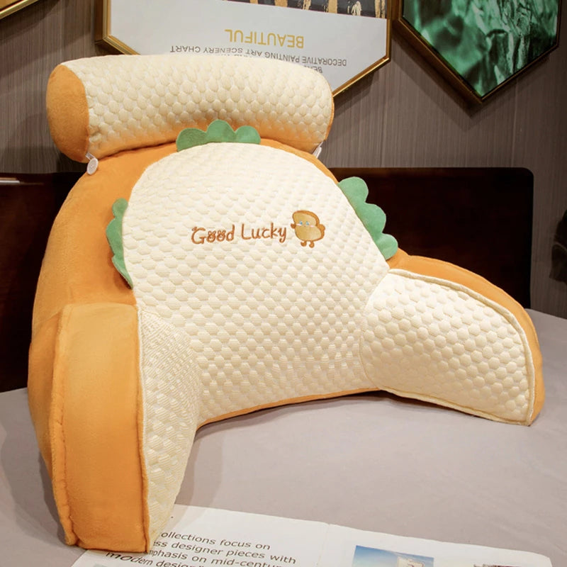Dinosaur-shaped pillow with 'Good Lucky' text on a surface