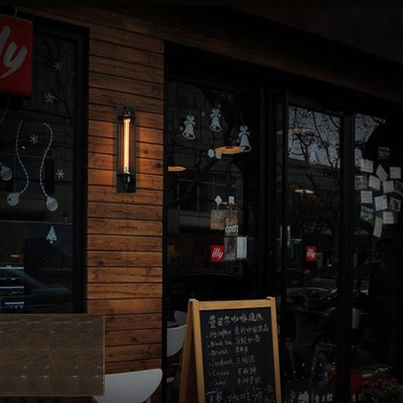 Outdoor setting with wooden wall, glass door, and chalkboard menu in a dimly lit area.