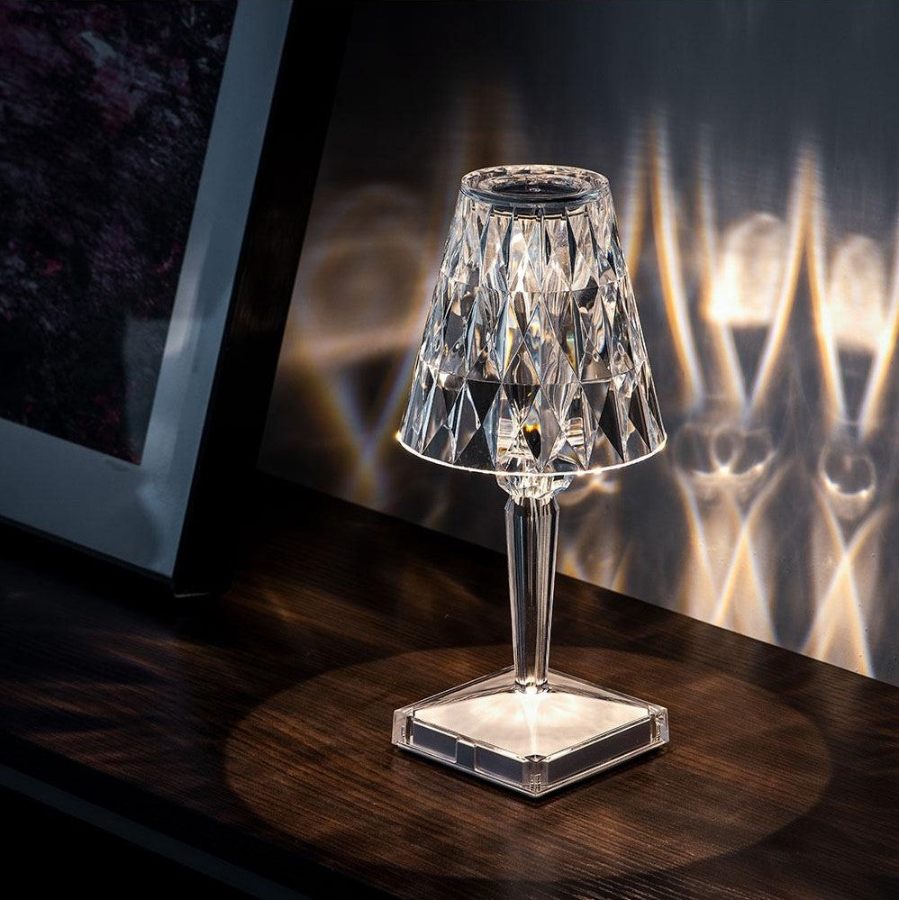 Crystal table lamp on a wooden surface with a dark background