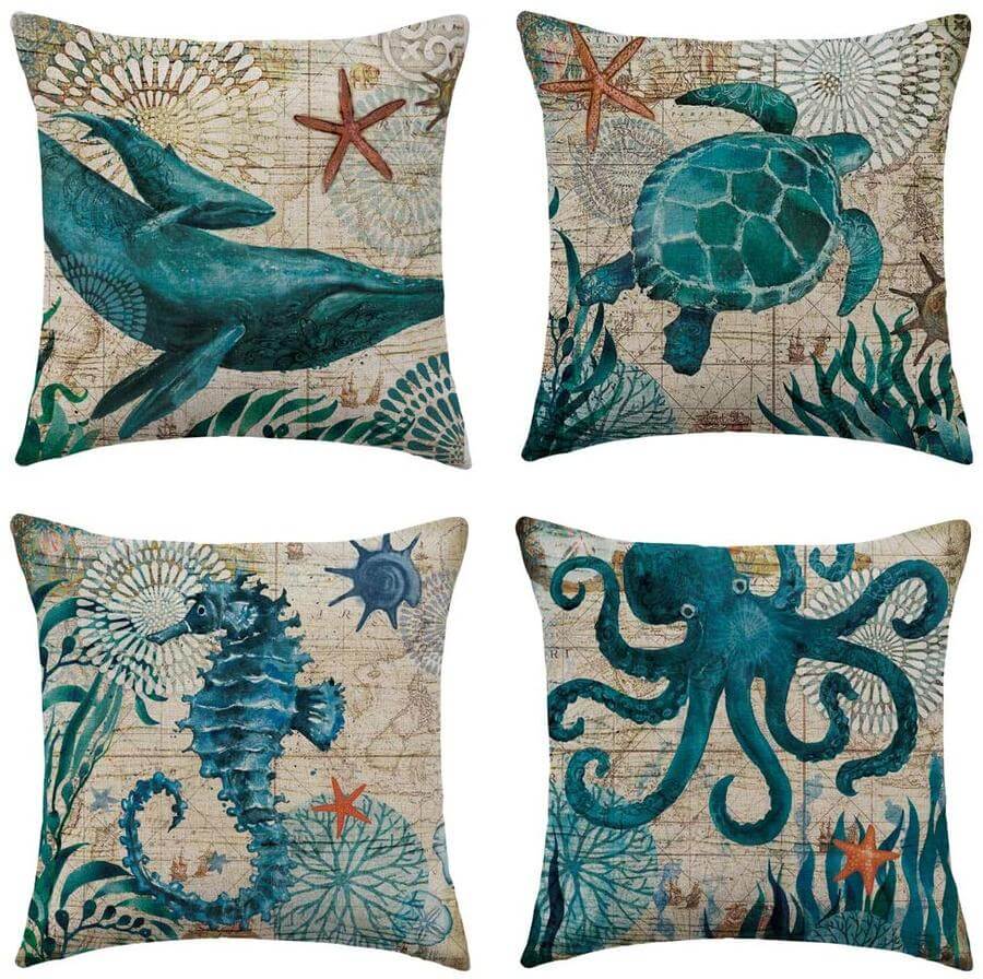 Set of four decorative pillows with ocean-themed illustrations on a beige background.