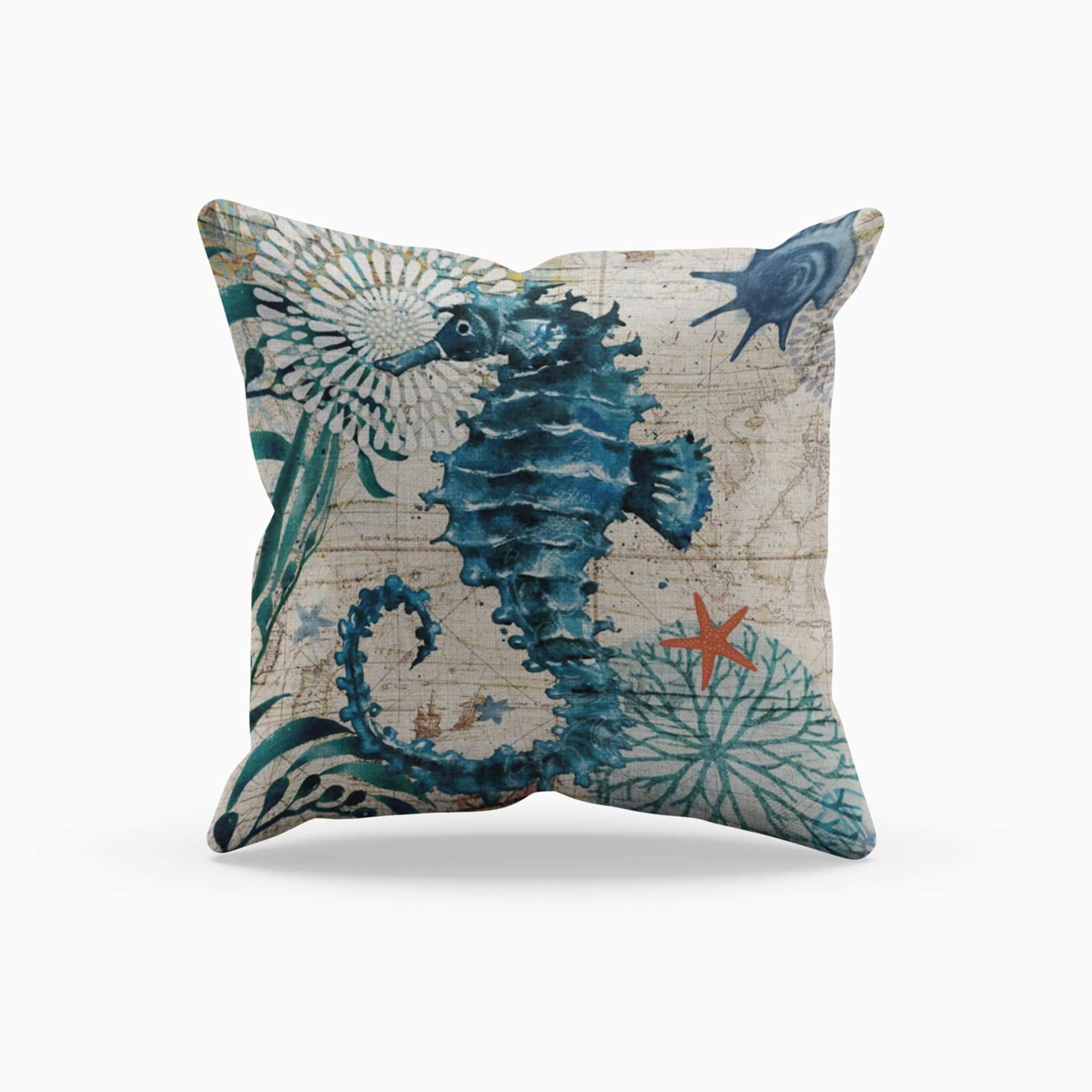 Decorative pillow with seahorse design on a white background