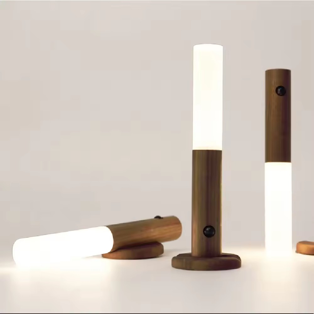 Wooden lamps with white cylindrical lights on a neutral background