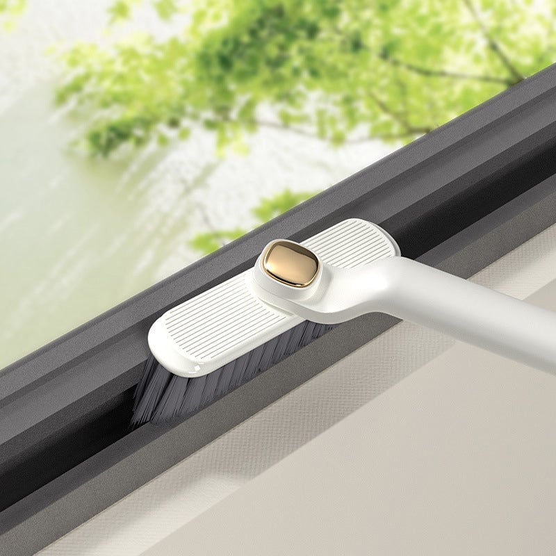 Window cleaning tool with a brush attachment being used on a window