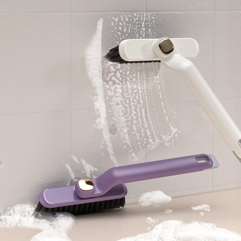 Cleaning brush with a white handle and purple handle cleaning a tiled wall.