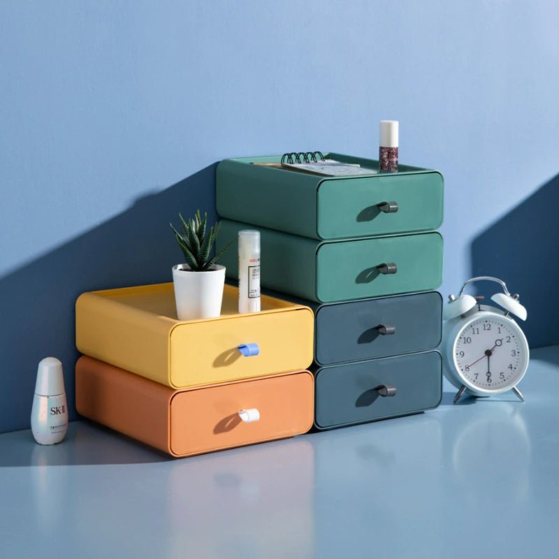 Stack of colorful drawers with cosmetic items on a blue background
