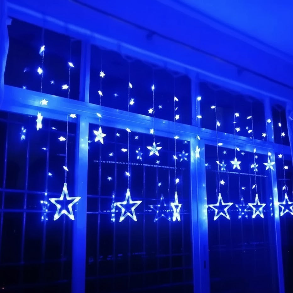 Star-shaped string lights on a window with a blue tint.