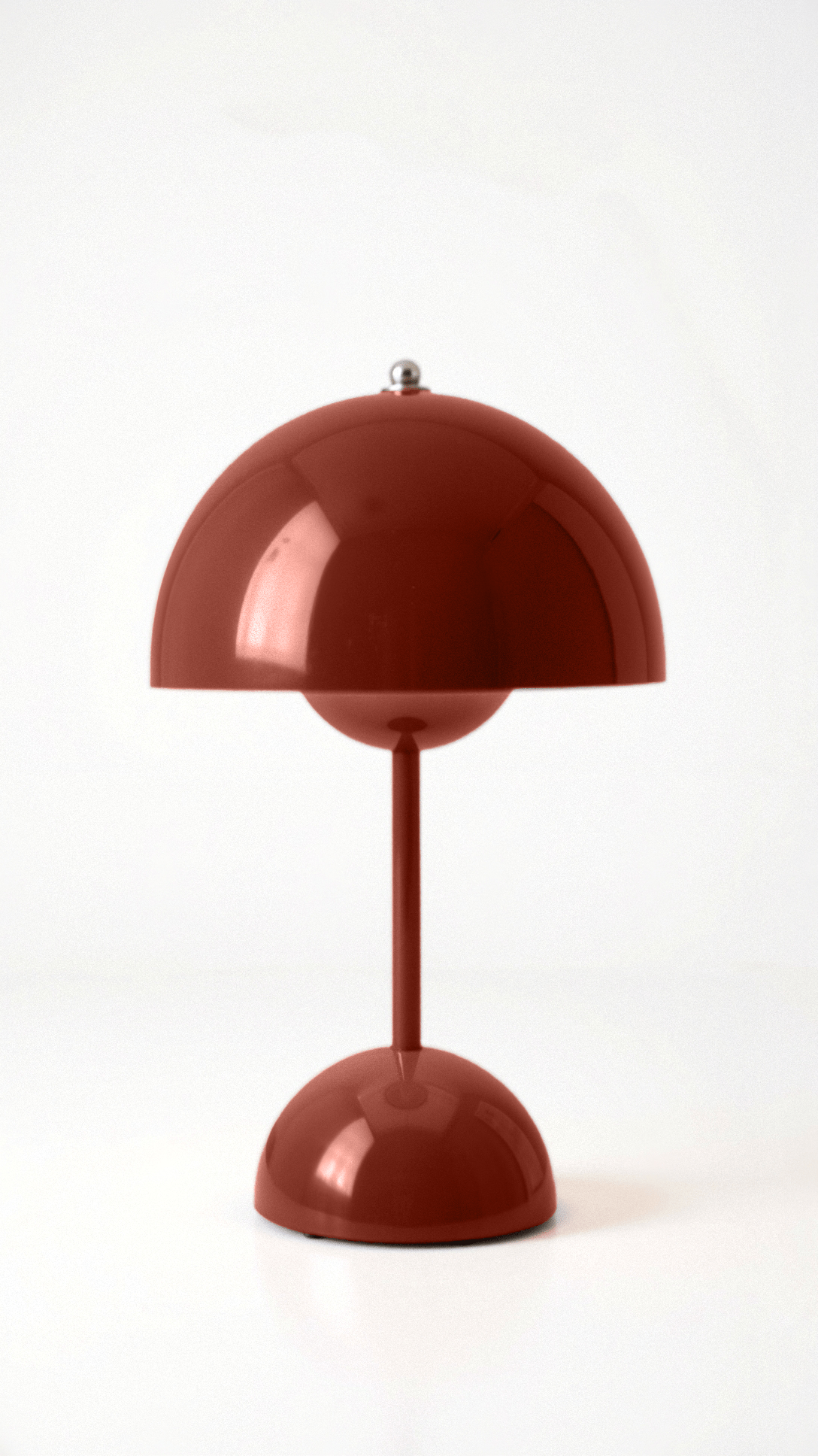 Red table lamp with a unique design on a white background